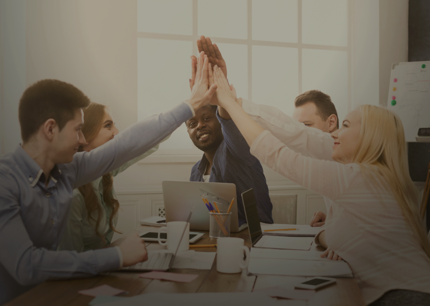 a group of people giving each other a high five